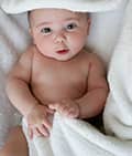 cute baby surrounded by towels